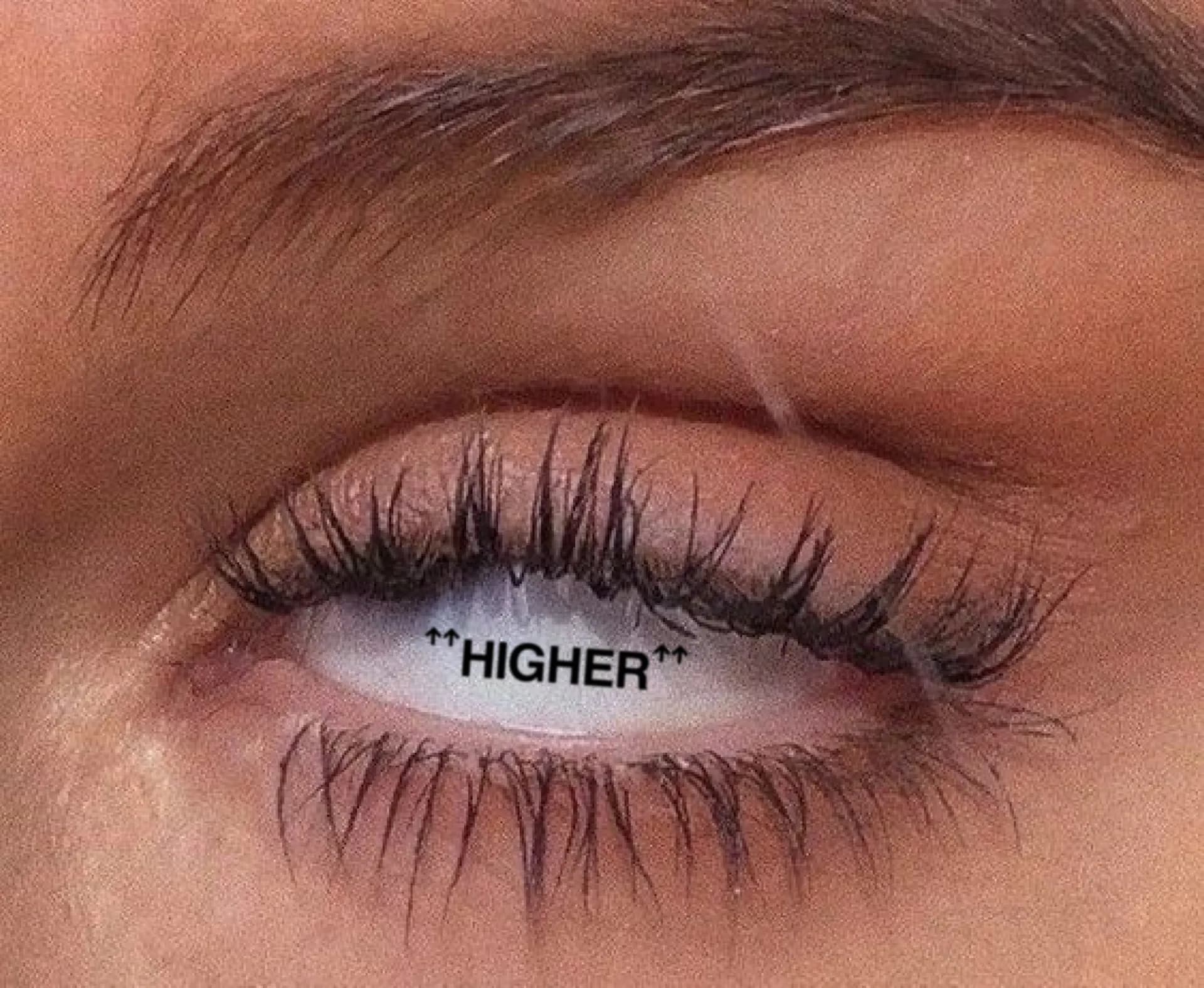 Higher wordmark reflected in an eye
